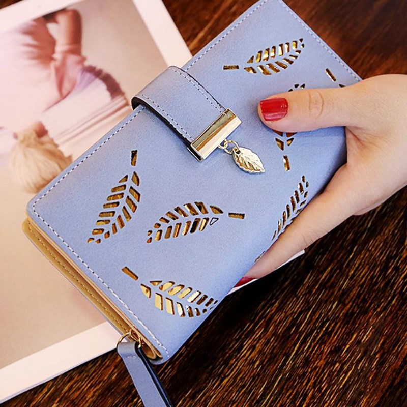 Model holding the Gold Leaf Print Pattern Wallet in sky blue and gold.