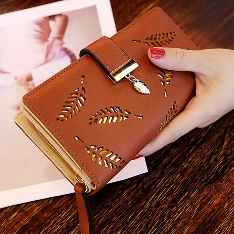 Model holding the Gold Leaf Print Pattern Wallet in coffee and gold.