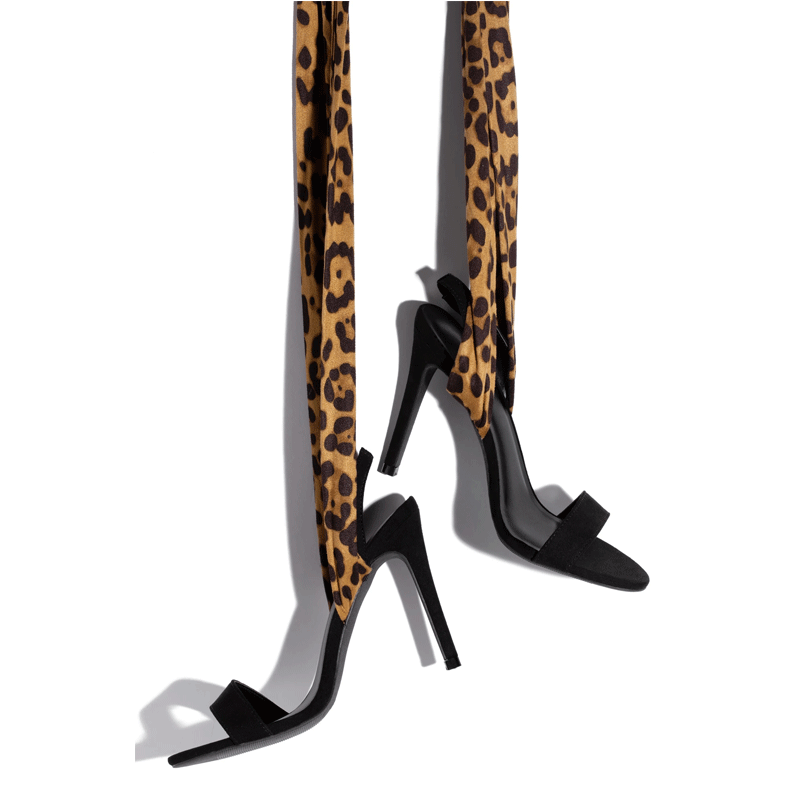 Laced Up Leopard Print Heels pictured hanging by its laces.