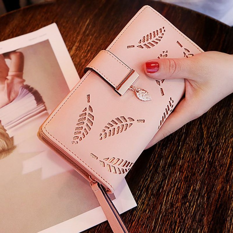Model holding the Gold Leaf Print Pattern Wallet in pink and gold.
