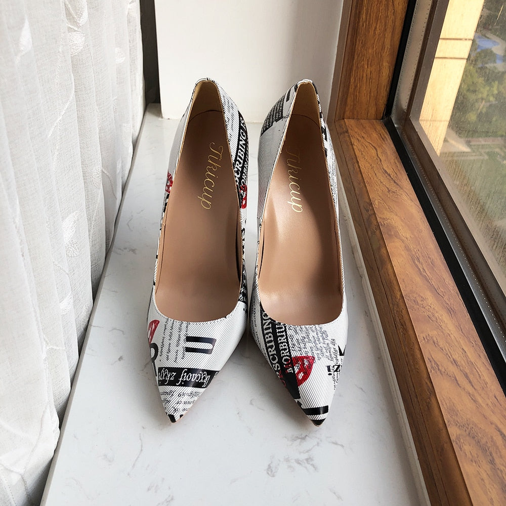 Front view of the Designer Graphic Newspaper Print Stilettos by a window.