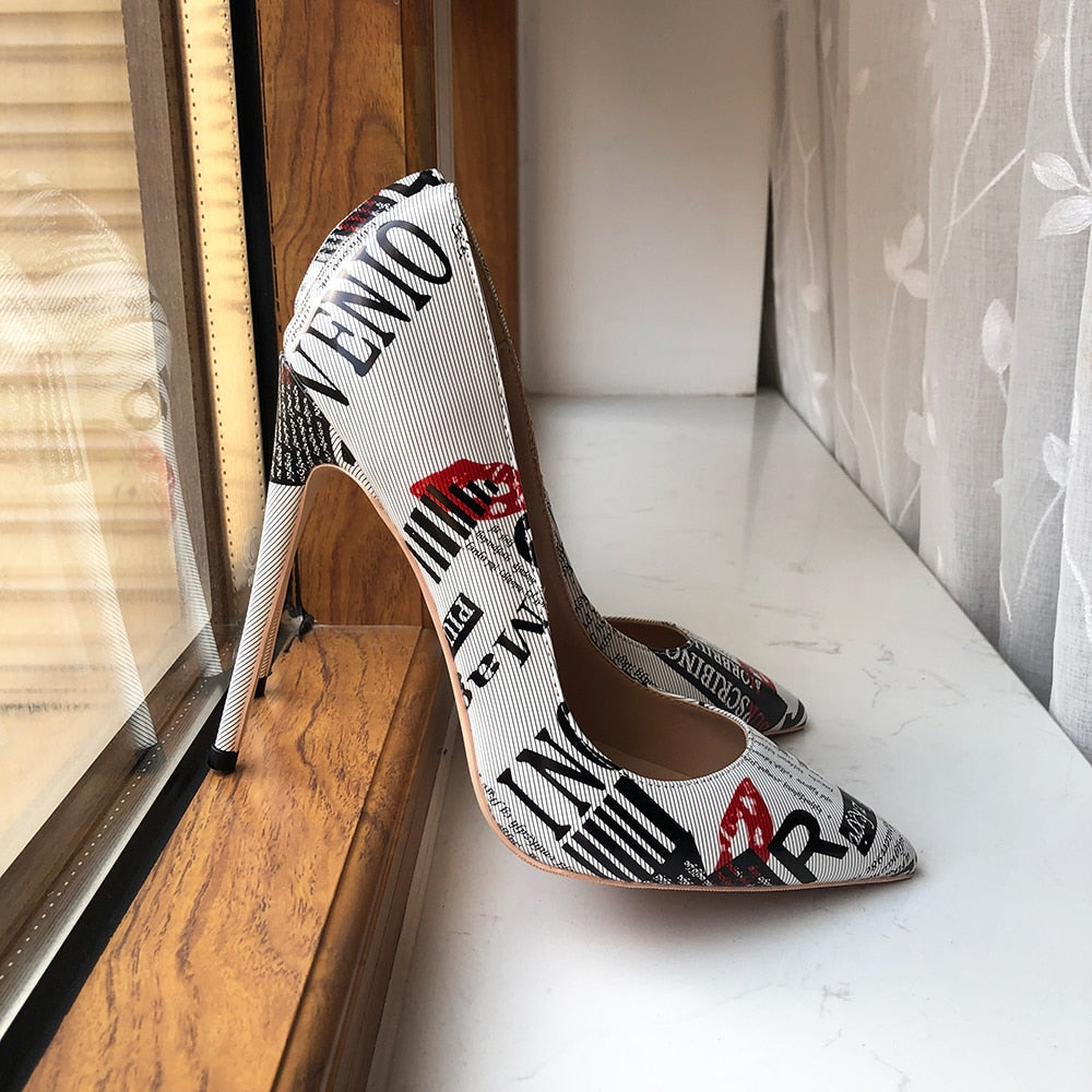 Side view of Designer Graphic Newspaper Print Stilettos propped up in the window sill.