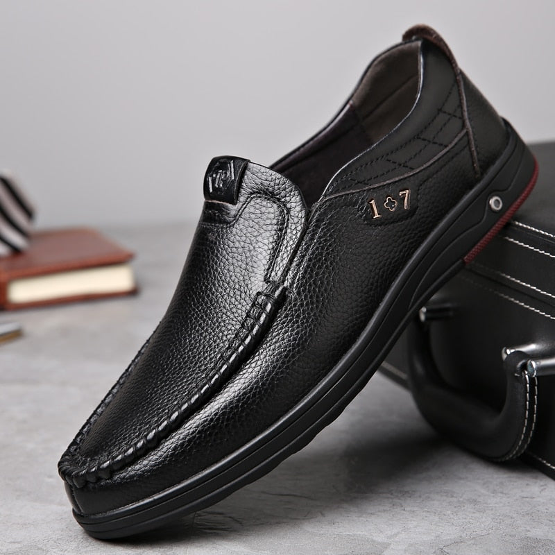 Business Casual Leather Loafers in black positioned against a briefcase.