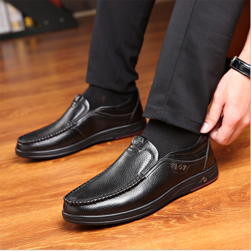 Business Casual Leather Loafers in black worn by a shoe model.